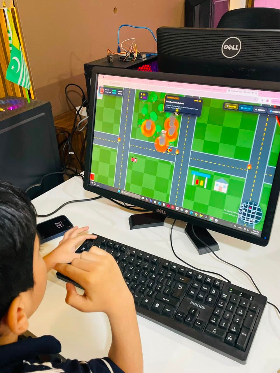 A student playing a 2D firefighter game they built with AI