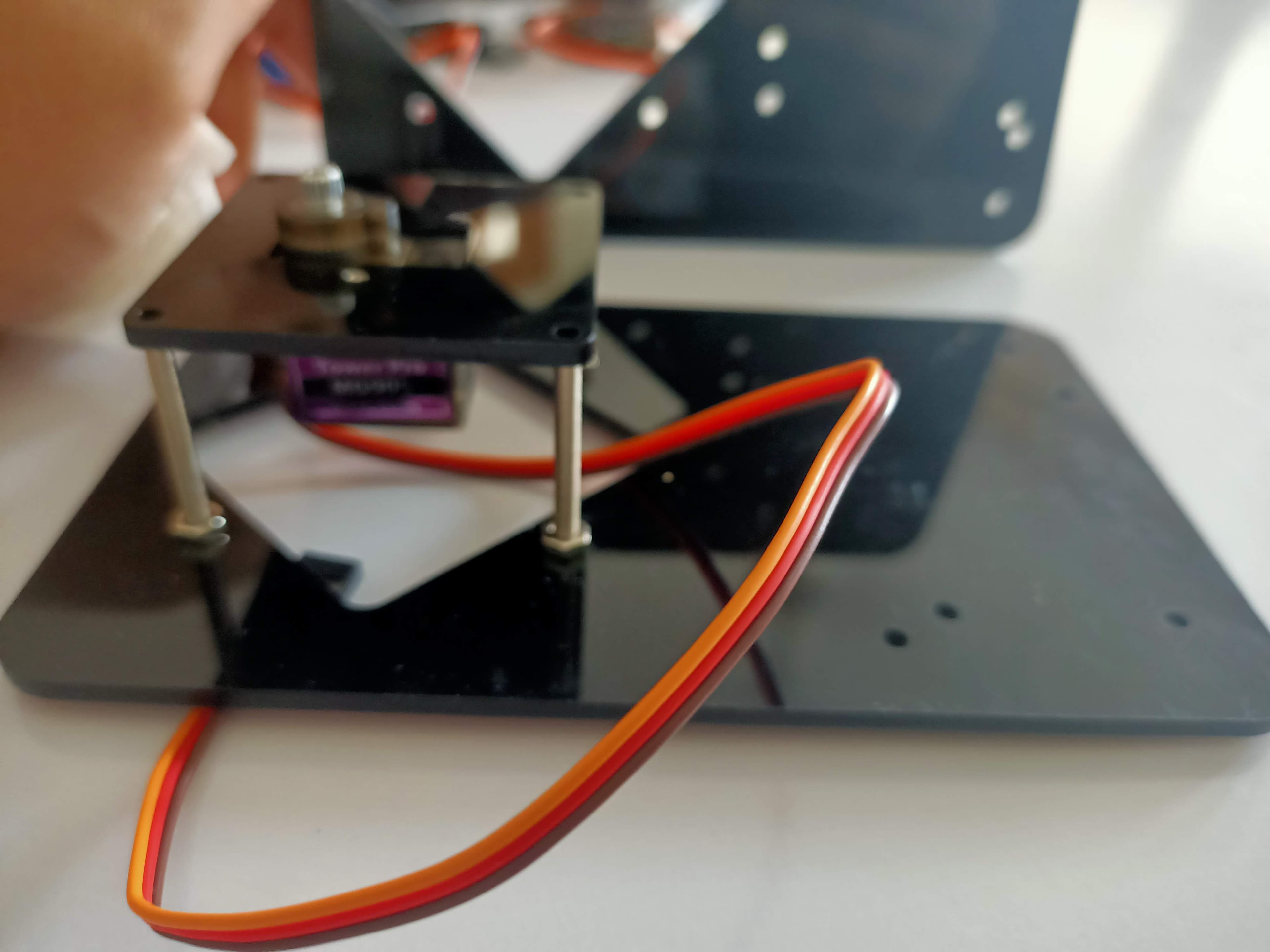 A student sketching their build plan beside an Arduino rover