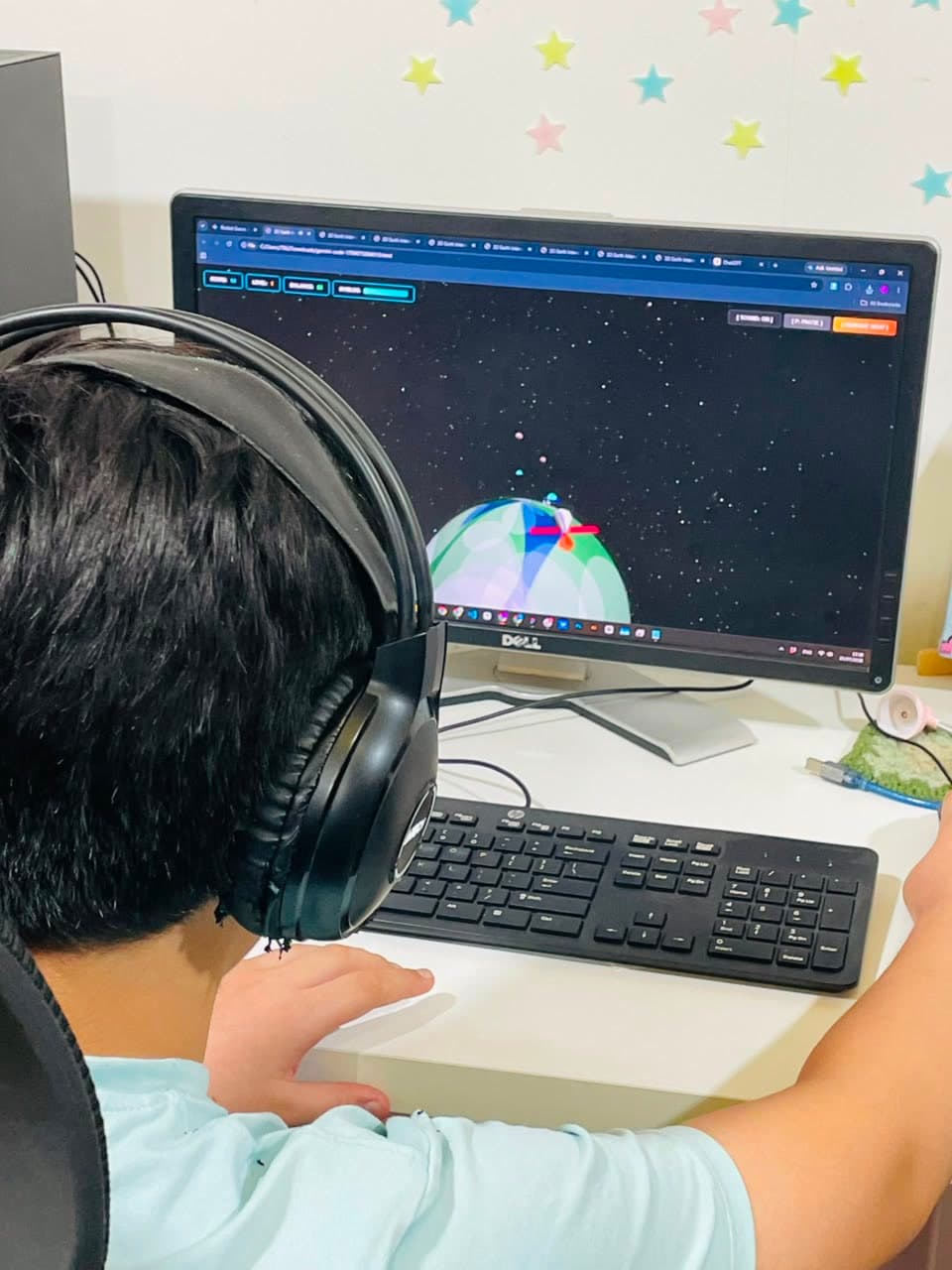 A student at a screen playing a 3D space game they built with AI